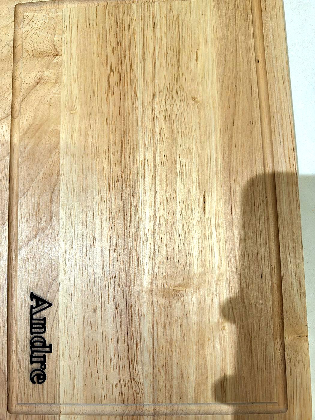 Hardwood board engraved with the name Andre