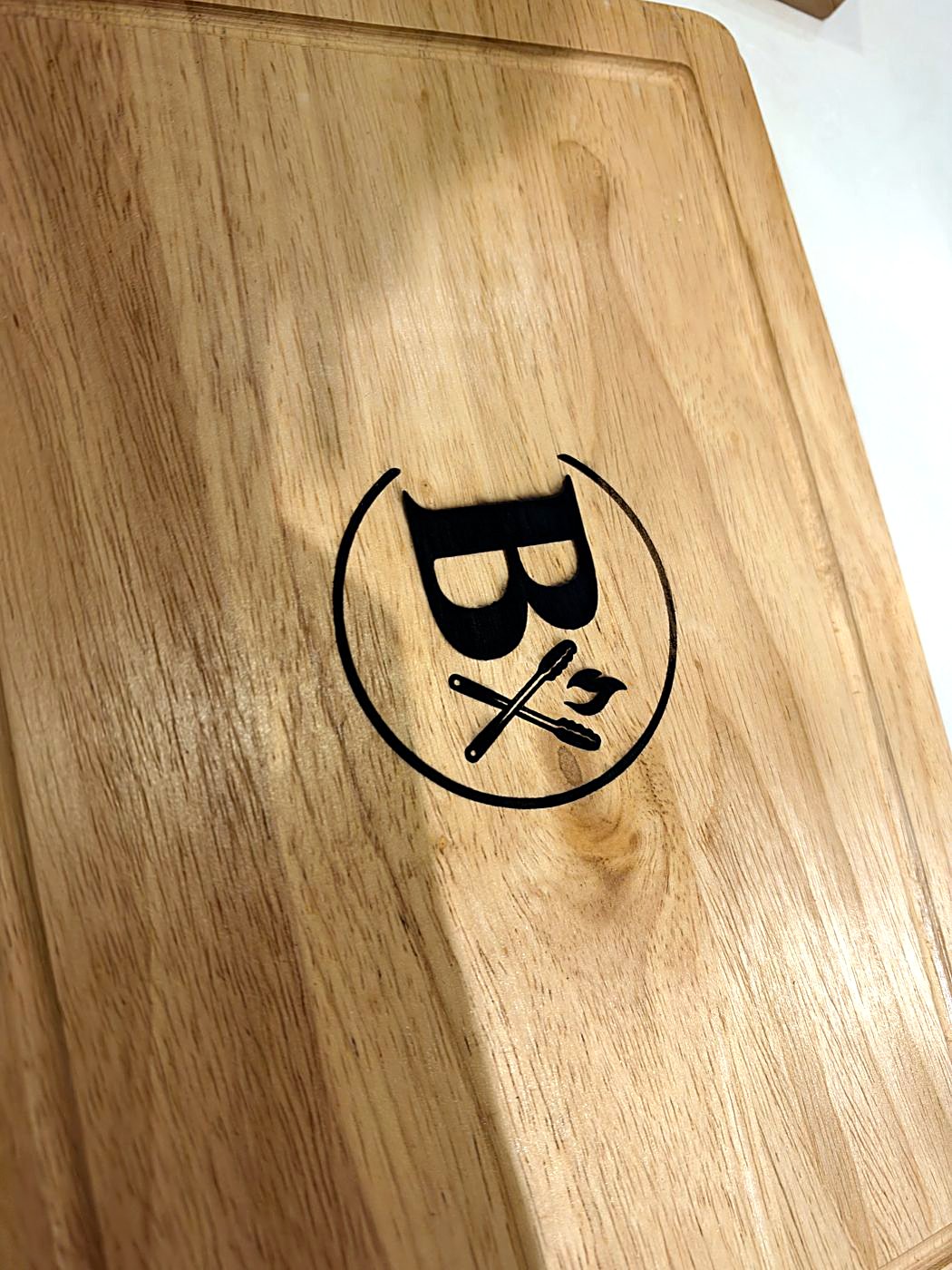 Hardwood braai board engraved with the Braaikis logo
